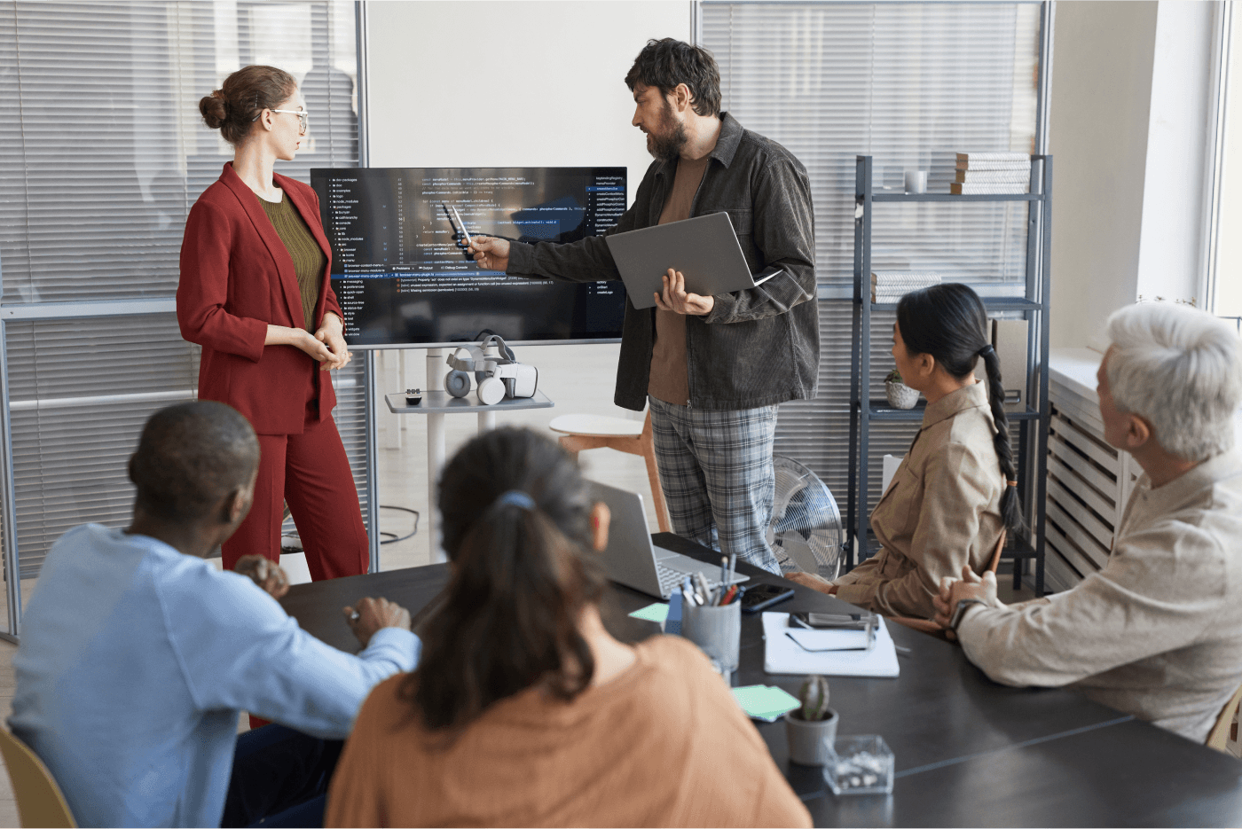 Employees discuss code at a general meeting