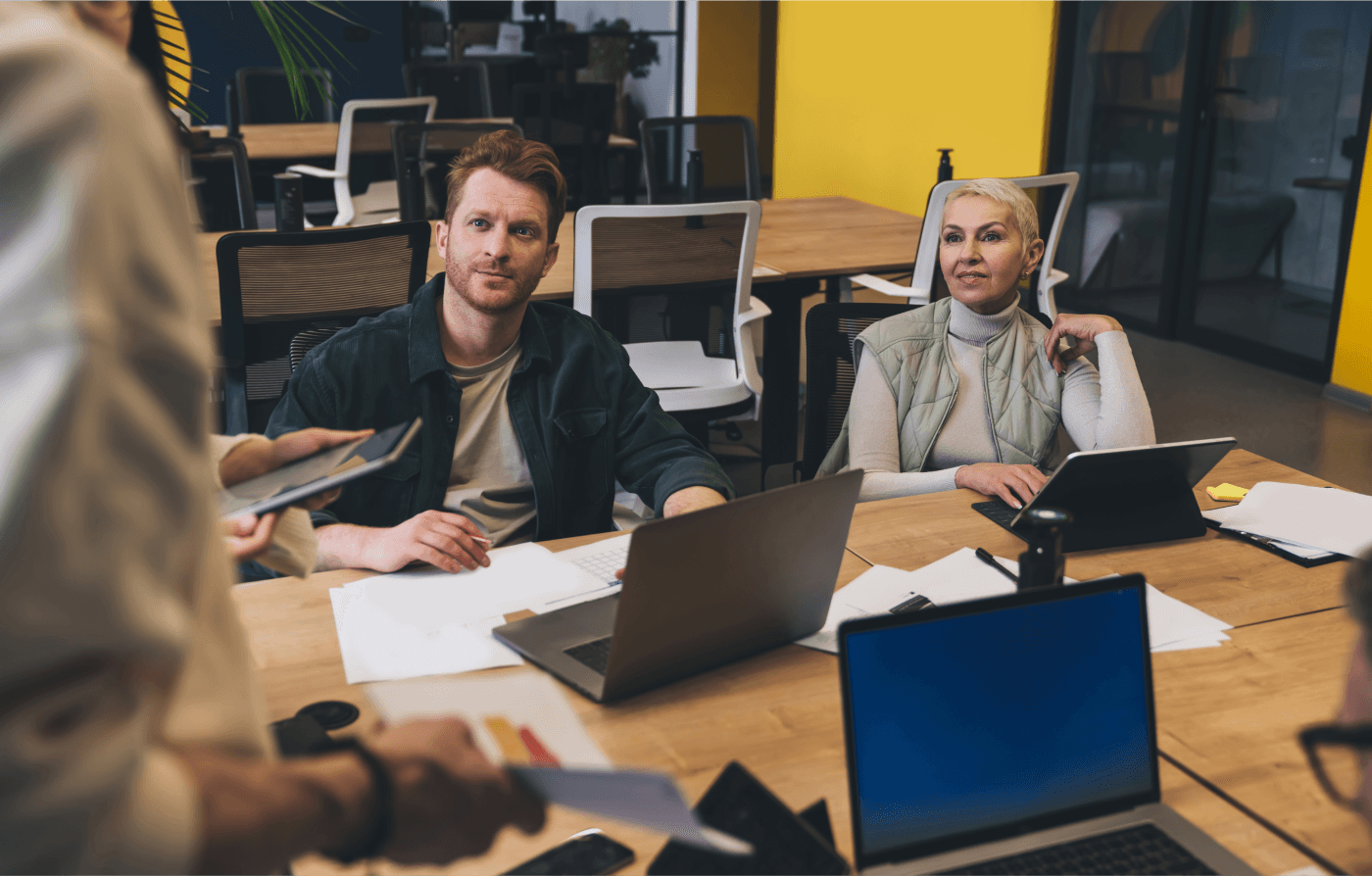 Employees having a discussion at their desk